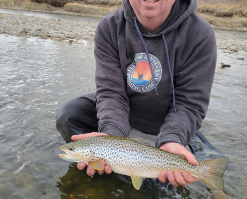 Scott, lead fly fishing guide, holding rainbow trout bow river