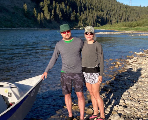 couple fly fishing drift boat in bow river