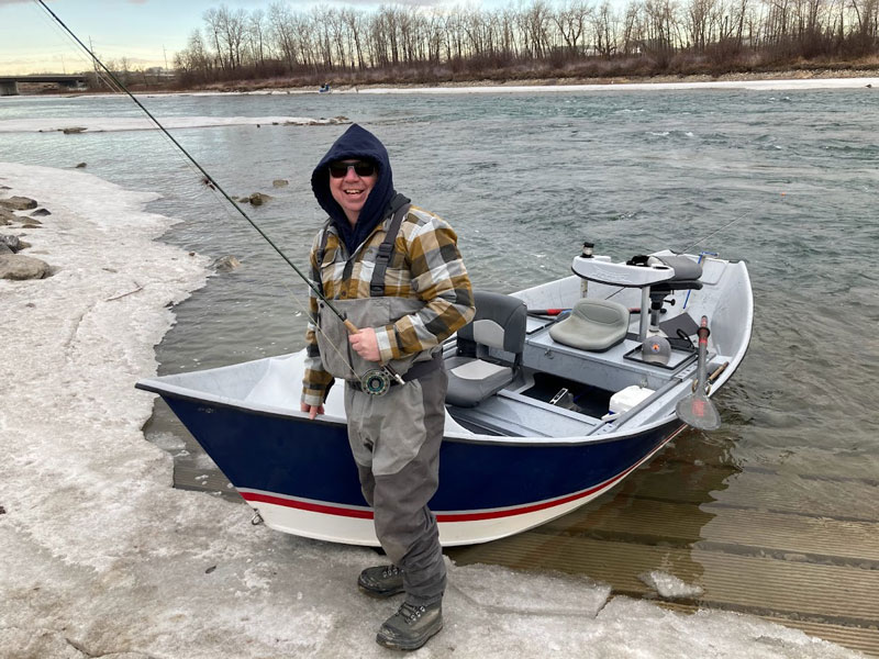 Scott fly fishing guide with drift boat on the bow river near Calgary.