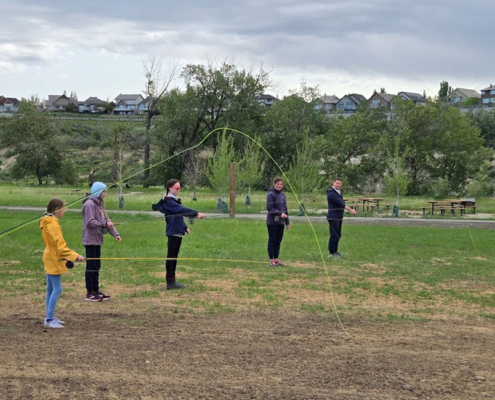 Youth fly casting lesson during early season Bow River training session.